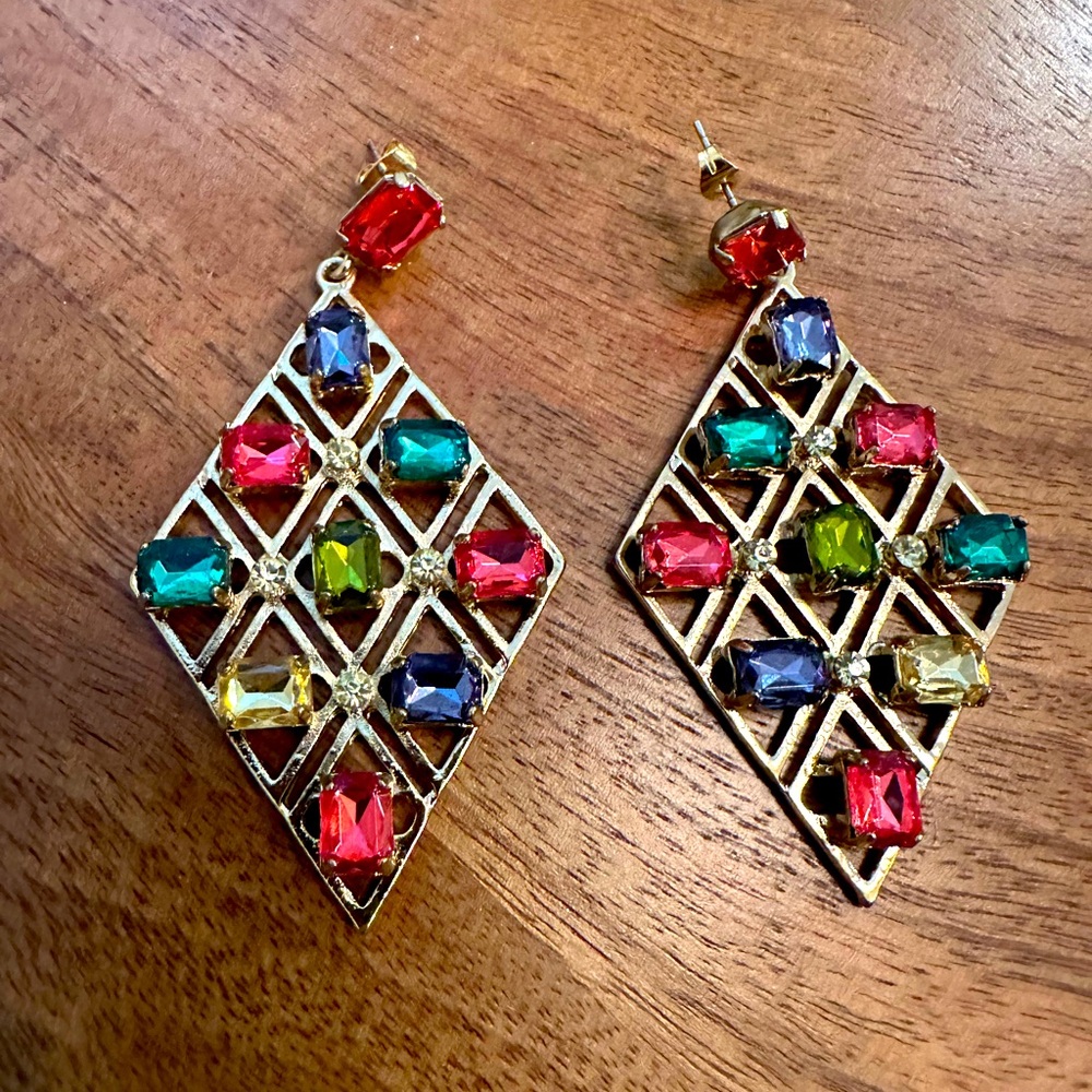 Fashion jewelry. Gold colored earrings with square colored stones.